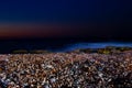 Colorful sea pebbles in the moonlight late at night