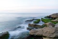 Colorful sea shore with green algae long exposure water at sunset time Royalty Free Stock Photo