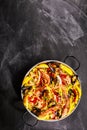 Colorful Seafood Paella Dish on Chalkboard Surface