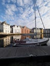 Colorful secessionist buildings of european Alesund town at Romsdal and yacht reflected in water in Norway - vertical Royalty Free Stock Photo