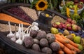 Colorful selection of fruits and vegetables in an old wooden carriage wheel.