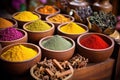 colorful selection of indian spices in wooden bowls