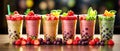 Colorful selection of milky fruit flavored bubble tea arranged in line on wooden table and bokeh background. panoramic banner