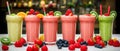 Colorful selection of milky fruit flavored bubble tea arranged in line on wooden table and bokeh background. panoramic banner Royalty Free Stock Photo