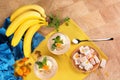 A colorful set of bananas, Turkish Delight, dried apricots, and sweet fruit desserts on a light wooden background. Royalty Free Stock Photo