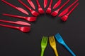 Colorful set of vibrant forks and knife isolated on black