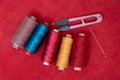 Colorful sewing essentials on red background Royalty Free Stock Photo