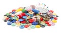 Colorful sewing supplies and buttons scattered on white background with spools of thread scissors and pins for crafting projects Royalty Free Stock Photo