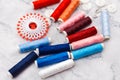 Colorful sewing and tailoring tools and items on light background