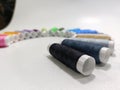 Colorful Sewing Thread Spools Arranged in a Rainbow Arc on White Background Royalty Free Stock Photo