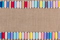 Colorful sewing threads on coarse burlap with copy space