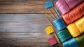 Colorful Sewing Threads and Needles on Wooden Surface Royalty Free Stock Photo