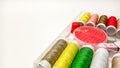Colorful Sewing Tools and Threads Arranged on a Clean White Workspace Royalty Free Stock Photo