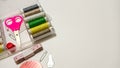 Colorful Sewing Tools and Threads Arranged on a Clean White Workspace Royalty Free Stock Photo