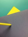 Colorful shapes of paper and yellow crayon