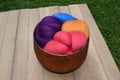 Colorful sheep wool roving in a copper colored glass bowl