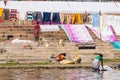 Colorful sheets and blankets near a ghat, waiting to get dried in the sunlight near the Ganges river. Indian lifestyle. Varanasi,