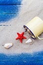 Colorful shells cup sand strewn blue boards Royalty Free Stock Photo