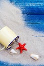 Colorful shells cup sand strewn blue boards Royalty Free Stock Photo