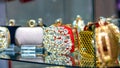 Colorful shiny diamond women handbags in a store