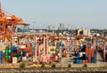 Colorful shipping containers and orange crane in port