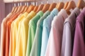 Colorful shirts on hangers in shop, closeup. Fashionable clothes