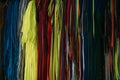 Colorful shoelaces hanging up and organized by color