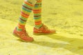 The colorful shoes and legs of one of the officials