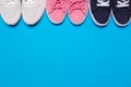 Colorful  shoes top view. Set of different sneakers on blue background, copy space Royalty Free Stock Photo