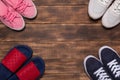 Colorful  shoes top view. Set of different sneakers on wooden floor, copy space Royalty Free Stock Photo