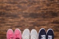 Colorful  shoes top view. Set of different sneakers on wooden floor, copy space Royalty Free Stock Photo