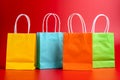 Colorful shopping or gift bags isolated on red Royalty Free Stock Photo