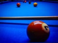 Colorful shot of 6 pool balls on a blue pool table , snooker table with a pool cue out of focus Royalty Free Stock Photo