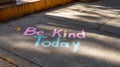 Colorful sidewalk chalk message: be kind today spreading positivity outdoors Royalty Free Stock Photo