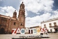 A colorful signage of the state of Zacatecas in Mexico with the Cathedral Basilica in the background