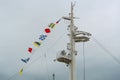 Colorful signal nautical flags against cloudy sky. Royalty Free Stock Photo
