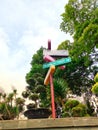 colorful signposts pointing to a beautiful city park