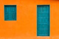 Colorful and Simple Orange Facade with Blue Greenish Door and Windows