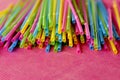 Colorful single use disposable plastic straws on pink surface Royalty Free Stock Photo