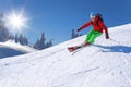 Skier skiing downhill in high mountains against blue sky Royalty Free Stock Photo