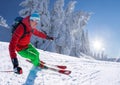 Skier skiing downhill in high mountains against blue sky Royalty Free Stock Photo