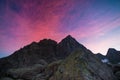 Colorful sky beyond rocky mountain peak on the Italian Alps at dusk.