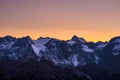 Colorful sky at dusk beyond the glaciers on the majestic peaks of the Massif des Ecrins 4101 m, France. Telephoto view from dist Royalty Free Stock Photo