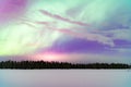 Colorful sky illuminated by spectacular purple and green lights.