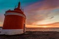 The colorful sky during the sunset near a red lighthouse Royalty Free Stock Photo