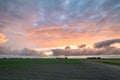 Colorful sky at sunset over wide open plain Royalty Free Stock Photo