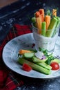 Colorful slices of raw vegetables in glasses carrots, celery, cucumber, sweet pepper and yogurt sauce. concept of diet