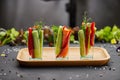 Colorful slices of raw vegetables in glasses carrots, cucumber, sweet pepper. The concept of diet, healthy and vegetarian food