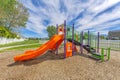 Colorful slides in a community playground with picket fence at Utah Valley