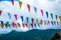 Colorful small flags with cloudy sky. Royalty Free Stock Photo